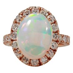 6.70 Carats Natural  Impressive Ethiopian Opal and Diamond 14K Solid Rose Gold Ring Suggested Replacement Value: $6,800.00 Total Natural Opal Weight is: Approx. 5.00 Carats  Total Natural Round Diamonds Weight: Approx. 1.70 Carats (color G-H / Clarity SI1-SI2) Ring total weight: 6.0 grams Disclaimer: all weights, measurements and colors are approximate and may vary slightly from the listed dimensions or as seen in the image. All pictures are magnified to show the smallest of details. Please, ref Ring Rosegold, Natural Opal, Opal Jewelry, Opal Rings, Ethiopian Opal, Cocktail Rings, Rings Statement, Rose Gold Ring, Or Rose