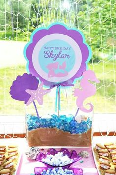 a birthday cake and cupcakes on a table