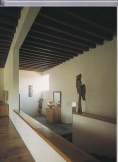 the interior of a house with wood floors and white walls, is seen through a glass window