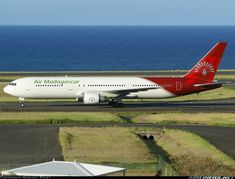 an airplane is on the runway by the water