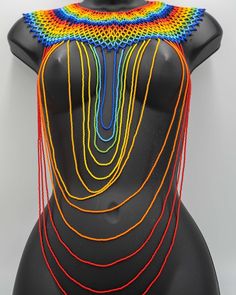 Show off some authentic, trendy, handmade, and vibrant designs from different regions in Africa!   Strut a new Waanje beaded necklace 😍 Place your orders NOW for this gorgeous and unique jewelry piece. Only one left!! ❤️ Unique Multicolor Beaded Necklaces, Unique Multicolor Beaded Necklace, Unique Multicolor Beaded Chain Necklaces, Unique Multicolor Beaded Necklaces For Festivals, Multicolor Beaded Necklace For Festival, Unique Multicolor Beaded Necklace For Festivals, Rainbow Necklaces With Tiny Beads For Festivals, Multicolor Bib Necklaces With Dangling Round Beads, Rainbow Tiny Beads Necklace For Festivals