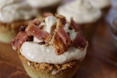 cupcakes with bacon and cream frosting on a wooden table