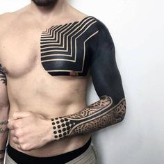 a man with tattoos on his chest and arm