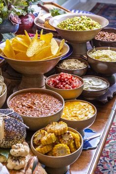 several bowls filled with different types of food on a table next to other foods and condiments