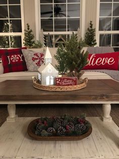 a living room filled with furniture and christmas decorations on top of a wooden coffee table