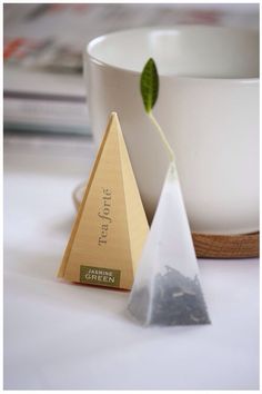 two pyramid shaped tea bags sitting next to each other