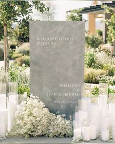 a welcome sign surrounded by candles and flowers