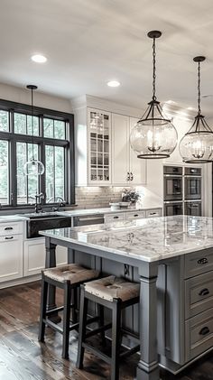 a large kitchen with an island and two stools