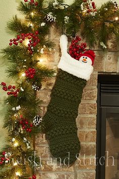 a christmas stocking hanging from a fireplace with the words, nail crochet christmas stockings