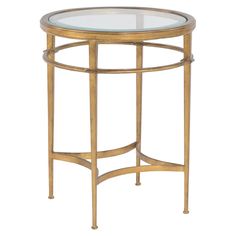 a round glass table with gold metal frame