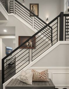 the stairs in this house have been painted white and are decorated with black railings