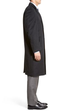 A touch of fine cashmere softens a rich overcoat that offers an effortless fusion of form and function, keeping you warm and stylish around town. 44" length (size 40R) 47" length (size 42L) Three-button closure Slant pockets; interior pockets Center vent Fully lined 90% wool, 10% cashmere Dry clean Imported Men's Furnishings Classic Black Cashmere Wool Coat, Classic Formal Cashmere Sweater Coat, Timeless Cashmere Outerwear For Winter, Gray Long Wool Coat For Business, Business Cashmere Long Wool Coat, Business Long Cashmere Wool Coat, Classic Wool Sweater Coat In Solid Color, Luxury Single Breasted Gray Outerwear, Cashmere Long Coat For Business