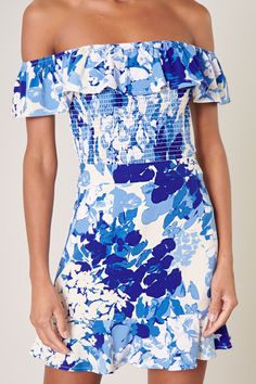 Cool like the sea, this blue abstract floral print embodies the perfect top for a warm day out to brunch. It features an off the shoulder design with a ruffle detail that sweeps from shoulder to shoulder. The bodice is fully smocked to create a flattering fit that ends right at the hips. Wear it with bottoms of your choice or complete the coord set with the matching skirt.- Smocked- Off the shoulder- Ruffle detail- Color: White BlueSize + Fit - Model is 5'9" and wearing size XS- Measurements tak Blue Smocked Top For Summer Brunch, Blue Smocked Top For Spring Day Out, Blue Floral Print Smocked Top For Vacation, Blue Smocked Top For Spring Beach Occasion, Blue Ruffled Smocked Top For Summer, Blue Smocked Top With Floral Print For Vacation, Blue Summer Smocked Top With Ruffles, Blue Smocked Summer Top With Ruffles, Blue Smocked Top For Summer Vacation