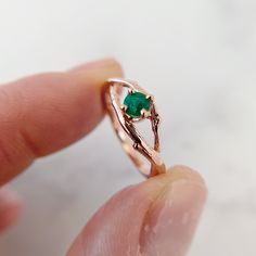 Our Green Emerald Solitaire Ring features a 4mm round emerald. Real twigs are molded to form the entwined twig band that creates a beautiful symbol of love, friendship and endless unity. Cast in solid gold or platinum. View video of this ring Find the perfect matching band with our stacking guide and ring pairing gallery: %%GLOBAL_ShopPathSSL%%/contour-ring-guide/ Nature-inspired Emerald Ring For May Birthstone, Emerald Solitaire Ring, Contour Ring, Ring Guide, Beautiful Symbols, View Video, Matching Band, Recycled Gold, Green Emerald