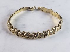 "FOR SALE IS A VINTAGE ESTATE 14K YELLOW GOLD LOVE BRACELET. THE BRACELET MEASURES 7\" LONG, BY 1/4\" WIDE, AND WEIGHS 6.0g. CONDITION IS VERY GOOD. THIS WOULD MAKE A LOVELY GIFT AND IS A GREAT VALUE FOR THE MONEY. IF ANY OTHER QUESTIONS, PLEASE ASK. BE SURE TO CHECK OUT SOME OF MY OTHER GREAT ITEMS UP FOR SALE. THANK YOU" Yellow Gold Bracelets For Valentine's Day Formal Occasion, Formal Yellow Gold Heart Jubilee Bracelet, Vintage Yellow Gold Bracelets, Vintage Gold Heart Bracelet For Anniversary, Vintage Gold Bracelets For Valentine's Day, Vintage Gold Bracelet Hallmarked, Vintage Yellow Gold Plated Bracelet, Vintage Gold Tarnish-resistant Bracelet, Luxury Vintage Gold-tone Bracelets