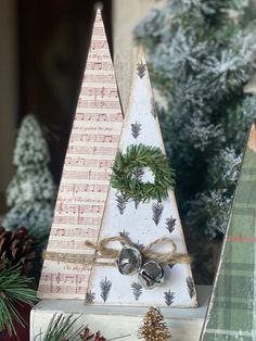 three christmas trees with bells and pine cones