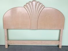 a wooden headboard with an art deco design