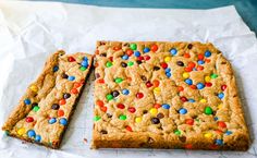 two cookie bars with m & m and chocolate chips on them