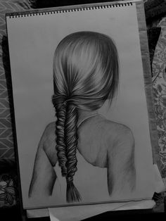 a drawing of a woman's back with a braid in her hair, on top of a table