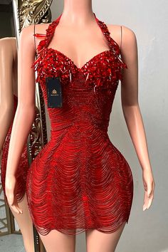 a mannequin wearing a red dress with sequins on it