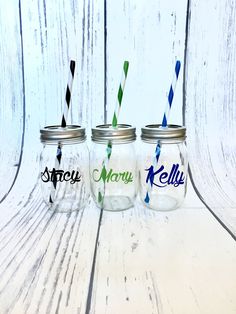 three mason jars with different colored straws in them