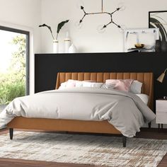 a bedroom with a bed, nightstands and plants on the headboard in front of a large window