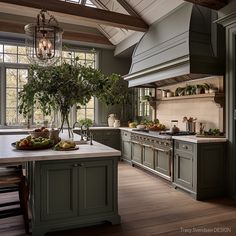 a kitchen with green cabinets and an island in front of the stove top is filled with fruit