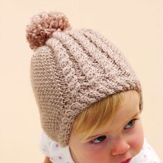 Free Intermediate Knit Hats Pattern For BabyA delicate hat with cable trim makes a darling gift for any tiny tot. Bernat Softee Baby is OEKO-TEX Standard 100 certified, so it's always safe to use. Select your color and let's get you on your way to completing a warm hat that looks priceless. Flat Knitting Patterns, Beany Hat, Baby Hat Knitting Patterns Free, Baby Hat Knitting Pattern, Knitted Hats Kids, Hat Knitting Pattern, Baby Knitting Patterns Free, Hat Knitting, Baby Hats Knitting