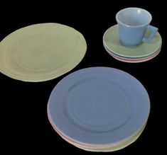 three plates and two cups on a black surface