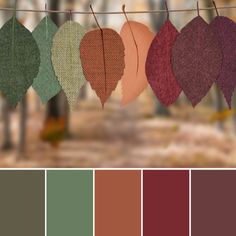 some leaves are hanging from a clothes line with color swatches in the foreground