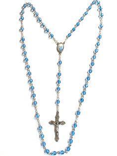 Rosary made with 5 decades makes a beautiful gift. It is 21 inches in length. Made with 6mm light blue glass beads. Stainless steel eye pins.  The center is 3/4 inch and the cross is 1 7/8 inch. Center and cross are silver oxidized and made in Italy.  Chain is silver oxidized also. Comes with a black pouch and beautiful white gift box.  Leave in comments if you would like the pouch with or without cross on it. If you want more quantity of this rosary just message me and I will do a custom order for you  😁 Lavender Car, Blue Rosary, Personalized Rosary, Beads Rosary, Black Pouch, Gold Rosary, Beaded Shoes, Decade Rosary, Rosary Prayer