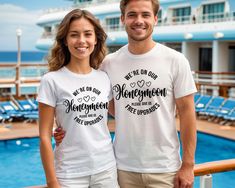 two people standing next to each other in front of a pool on a cruise ship