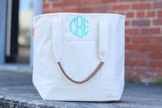 "listing is for tote only please list initials thread and font in the notes to seller at checkout 14.5\" H x 18.75\" W x 6\" D 2.05 lbs Inside Organizer, 1 outside pocket 18 oz Canvas Finally a classic all natural statement tote for all seasons! Open Top/ No Closure 2 cotton web handles with a 9.5 inch handle drop accessorized with a hit of Genuine Leather on both straps. 1 outer pocket perfect for storing small items. 1 detail inside organizer pocket pocket perfect for keeping things handy and Guitar Strap Bag, Beach Bag Gift, Plaid Purse, Tote Bag Beach, Everyday Tote Bag, Monogram Tote Bags, Monogram Tote, Personalized Tote Bags, Everyday Tote