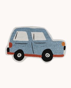 a blue car shaped rug sitting on top of a white floor