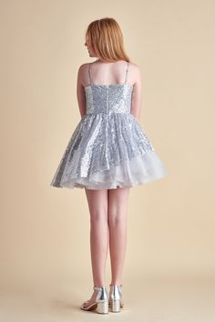 This is an all over sequin dress with a full sequin and tulle asymmetrical skirt for ultimate twirling. Features adjustable straps and high waist detailing. Model is wearing a size 12Model measurements: bust 29", waist 25" height 4'8Runs true to sizeMaterial: Polyester/SpandexHand wash, do not bleach, hang to dry.Made in the USA. Asymmetrical Skirt, Knee Dress, Peek A Boo, Modest Dresses, Above The Knee, Sequin Dress, Fitted Dress, Graduation Dress, Dresses For Sale