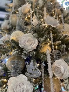 a decorated christmas tree with white and silver ornaments