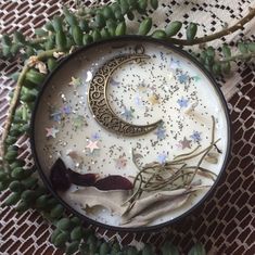 the moon and stars are sitting in a bowl