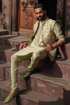 Mint green kurta with all over floral prints. Paired with a quilted bundi with floral prints and a churidar. - Aza Fashions Bollywood Style Green Nehru Jacket, Green Bollywood Nehru Jacket, Green Long Sleeve Sherwani For Spring, Spring Green Embroidered Sherwani, Spring Embroidered Green Sherwani, Green Zari Work Outerwear For Eid, Green Outerwear With Zari Work For Eid, Green Embroidered Bandhgala For Spring, Embroidered Green Bandhgala For Spring