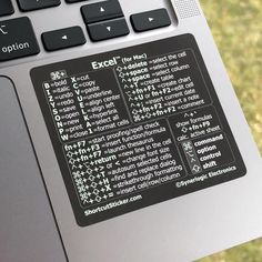 a computer keyboard with some type of sticker on it's back side and the words excel written in different languages