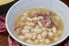 a white bowl filled with beans and bacon