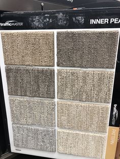 carpet samples for sale in a store display case with the words inner peace written on them