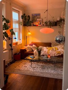 a living room filled with furniture and plants