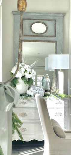 a white dresser and chair in a room