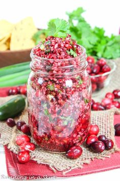 a jar filled with cranberry sauce and garnish