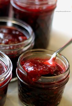 jars filled with jam sitting on top of a table