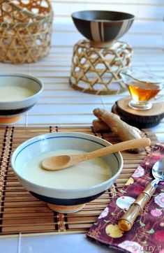 two bowls and spoons on a place mat