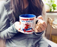 a woman holding a coffee mug in her hands