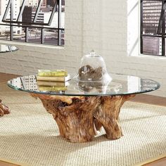 a glass table sitting on top of a rug in a living room next to a window