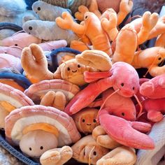 a basket filled with lots of different colored stuffed animals