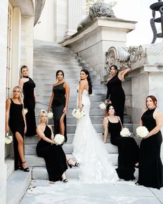 a group of women in black dresses posing on steps